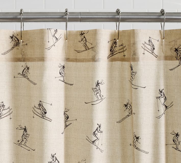 a shower curtain with drawings of skiers on it