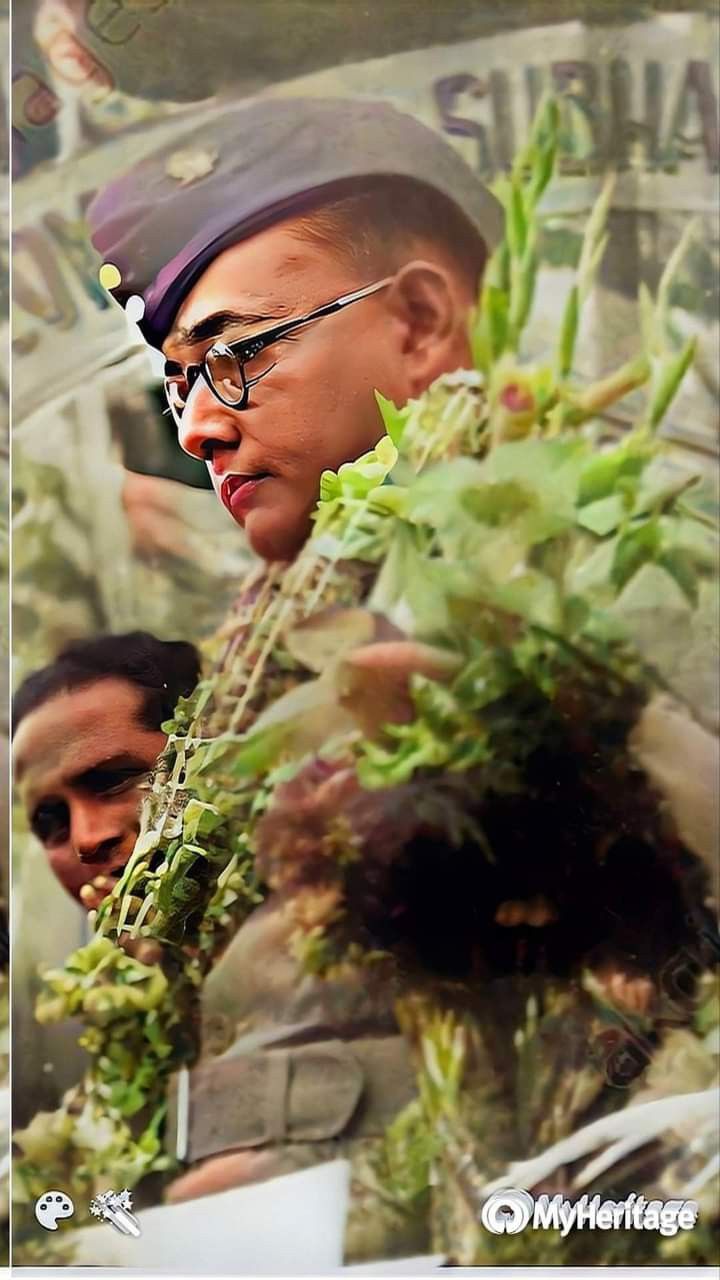 a man wearing glasses and a hat with flowers on it