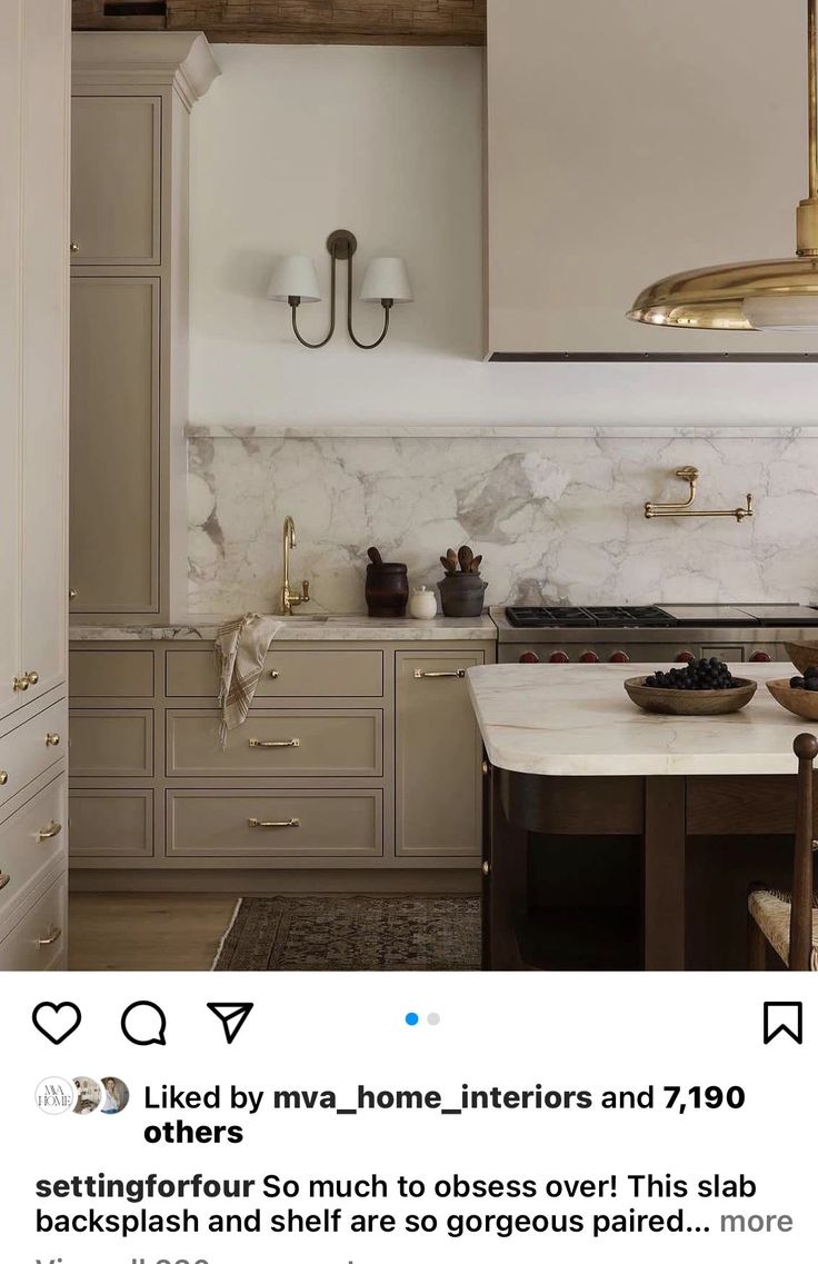 a kitchen with marble counter tops and gold fixtures