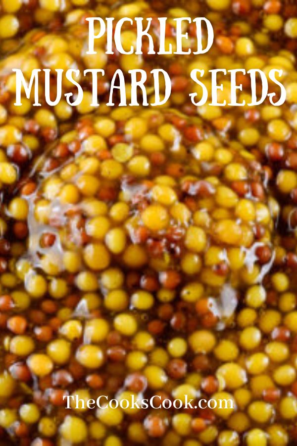 the top view of a bowl filled with yellow and red beans, text reads pickled mustard seeds