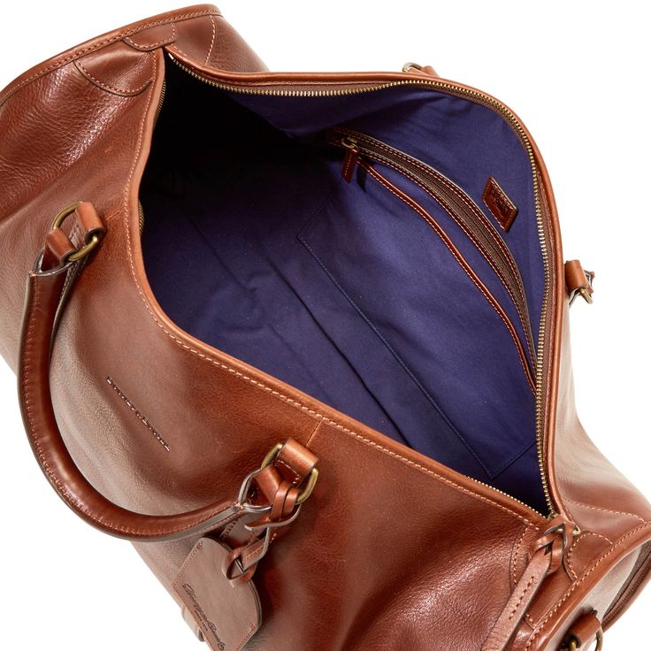 Gym and Go    This sleek gym bag, made from Italian Vacchetta leather that grows softer with age, is durable and classic, perfect for a weekend escape. Weekend Escape, Saddle Leather, Dooney And Bourke, Dooney & Bourke, Luggage Tags, Dooney Bourke, Chestnut, Inside Pocket, Gym Bag