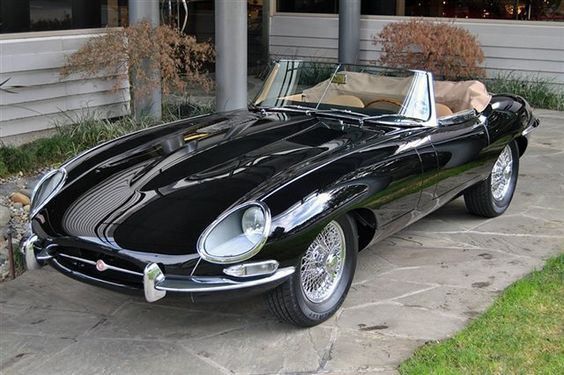 a black sports car parked in front of a building