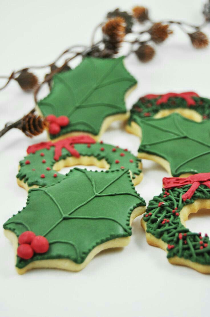 decorated cookies with holly leaves and red berries