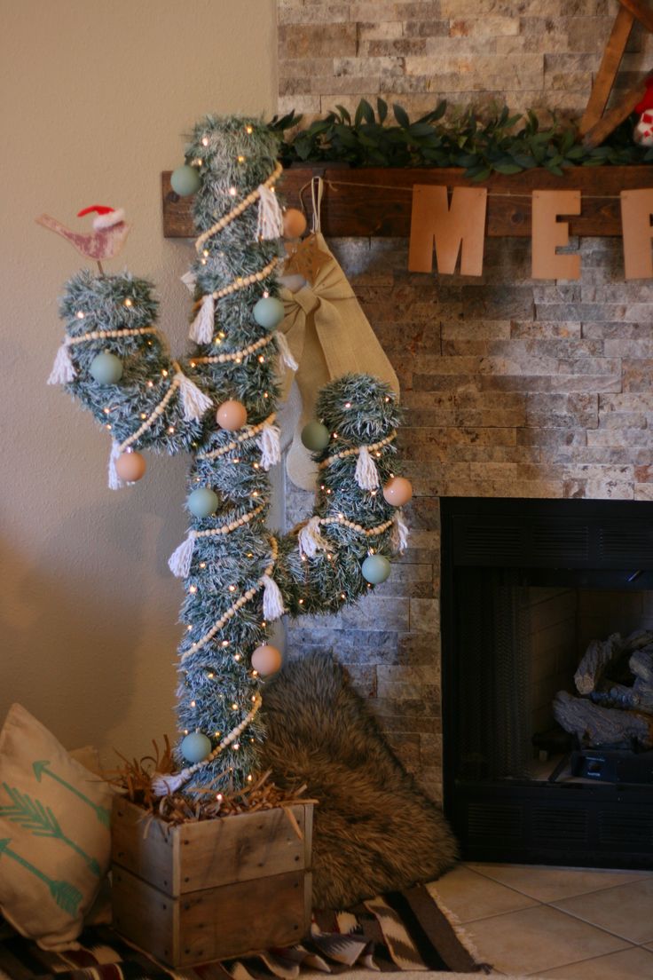 a decorated christmas tree in front of a fireplace