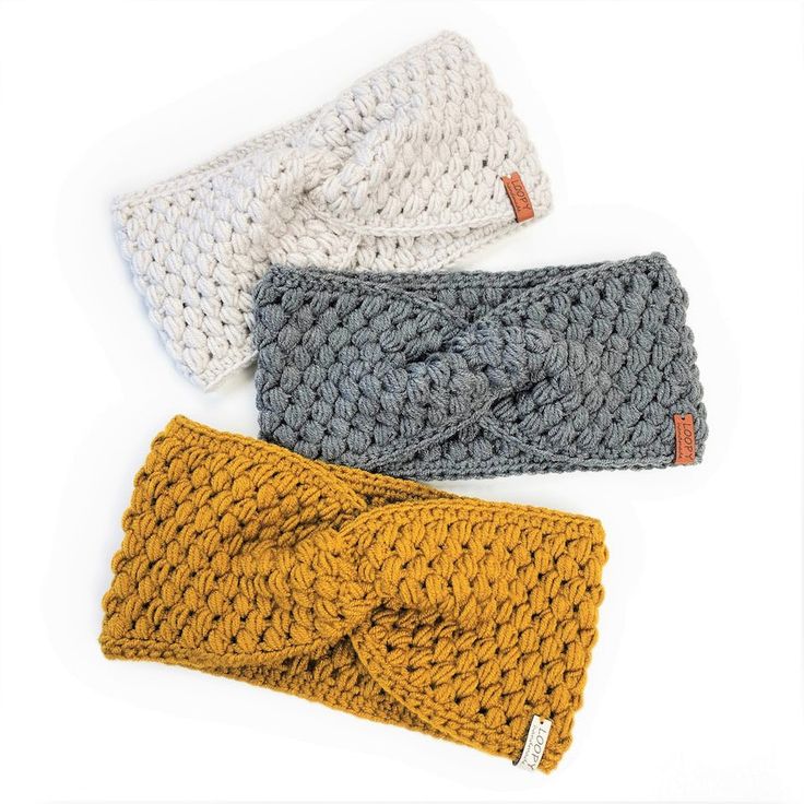 three crocheted headbands are laying on top of each other