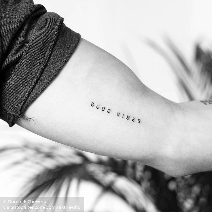 a woman's arm with the words good vibes tattooed on her left arm