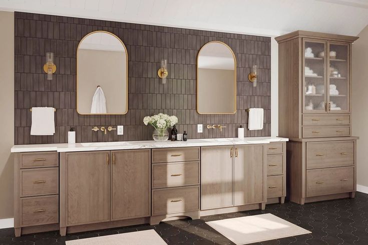 a bathroom with two sinks, mirrors and rugs in front of the bathtub