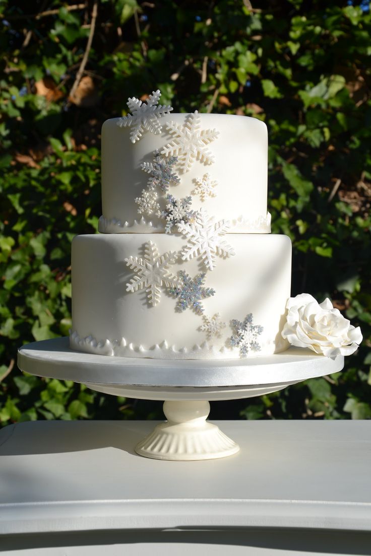 a white wedding cake sitting on top of a table