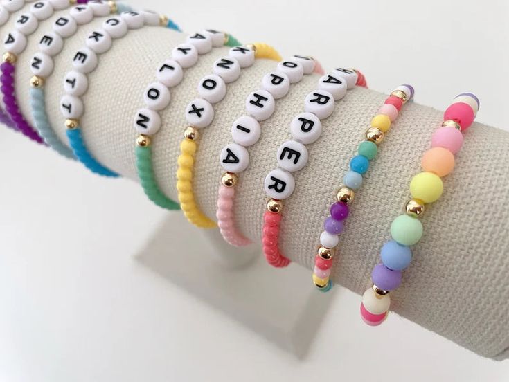 one colorful beaded name bracelet bracelets are made on a durable stretch elastic cord please refer to our sizing guide before purchasing Personalized Casual Colorful Beaded Bracelets, Everyday Multicolor Hypoallergenic Stretch Bracelet, Trendy Adjustable Name Bracelet With Round Beads, Trendy Stretch Bracelet With Letter And Heishi Beads, Cute Stretch Bracelet With Colorful Beads, Trendy Letter Beads For Friendship, Trendy Bracelet With Letter Beads, Trendy Friendship Bracelets With Round Beads For Everyday, Trendy Colorful Bracelets With Letter Beads