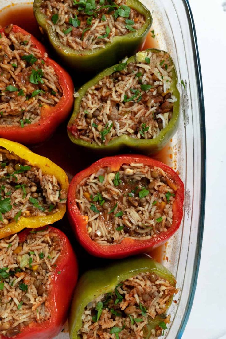 stuffed peppers with rice and herbs in a casserole dish