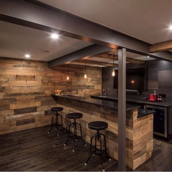 a bar with stools and wooden walls