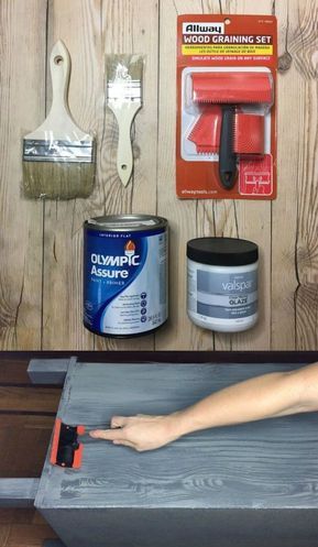 a person using a brush to paint the side of a wooden table with various items on it