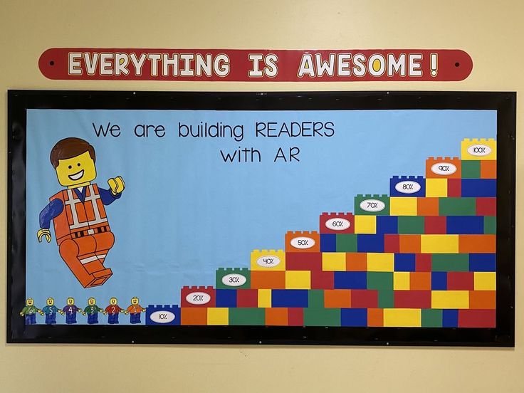 a bulletin board with legos on it that says, everything is awesome we are building readers with ar