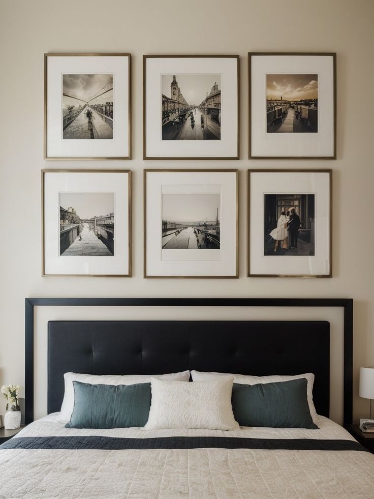 a bed with four framed pictures on the wall above it