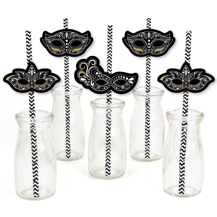 black and gold masquerade party straws in vases with striped paper straws