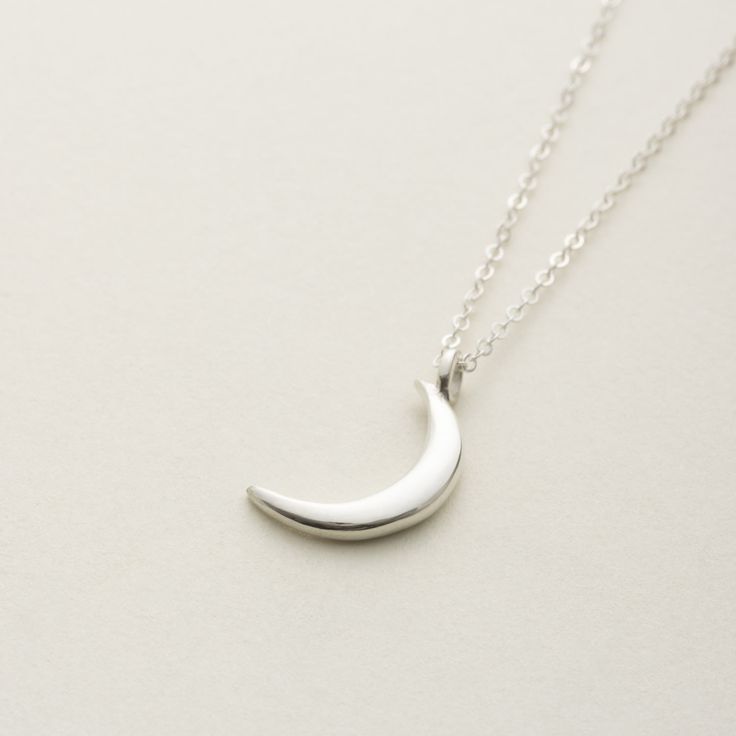 The necklace with the image of a delicate new moon is You can wear it simply and without hesitation.  The moon motif of thes necklace is somewhat mysterious and gentle. Matching earrings are also available. Anyway, I recommend this jewelry as a cute and versatile bracelet! "Sterling Silver" Sterling silver(sv925)  Made in Japan.  Care Guide To make your delicate jewelry last for a long time, please follow these guidelines: Avoid putting on or taking off clothes while wearing jewelry, as it can c Dainty Silver Moon Shaped Jewelry, Silver Crescent Sterling Silver Charm Necklace, Elegant Silver Charm Necklace With Moon Charm, Sterling Silver Moon Phase Charm Necklaces, Sterling Silver Moon Clavicle Chain, Sterling Silver Moon Clavicle Chain Jewelry, Elegant Sterling Silver Crescent Charm Necklace, Elegant Everyday Crescent Charm Necklace, Sterling Silver Moon Charm Pendant Necklace