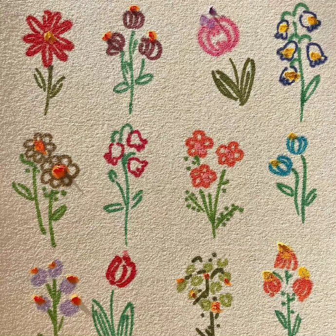 an embroidered wall hanging with flowers on it