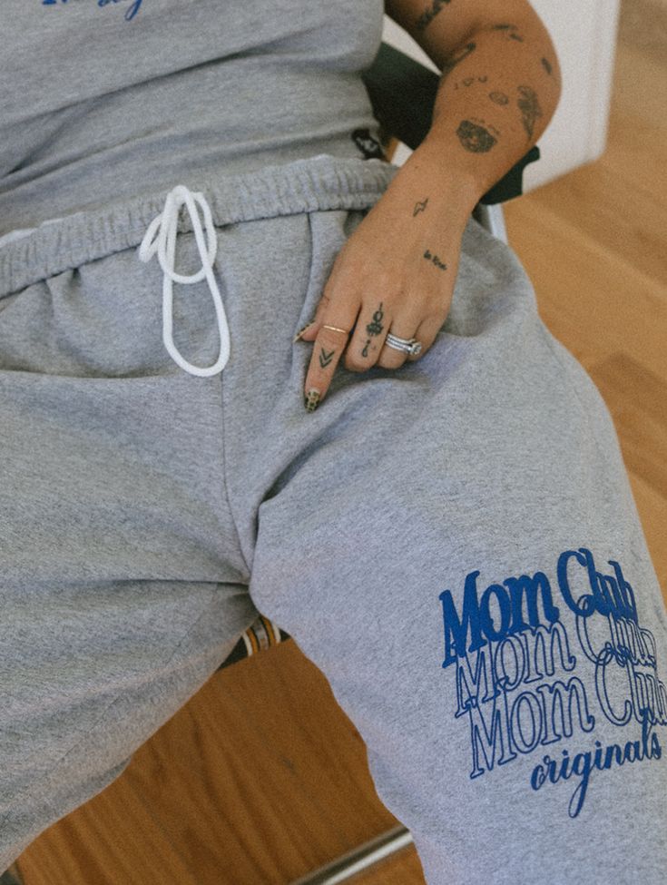 Level up your loungewear game with our Gray Mom Club Open Bottom Sweatpants – the epitome of chic comfort! Crafted from soft, high-quality fabric in a versatile shade of gray, these sweatpants redefine trendy relaxation. Featuring a stylish "Mom Club" puff print, they effortlessly combine fashion and function, allowing you to slay the mom duties in absolute style. 👖👩‍👧‍👦✨ #MomClubChill #TrendyMomEssentials Size chart in images :) Comfortable Gray Sweats For Loungewear, Comfortable Gray Sweatpants For Loungewear, Gray Joggers With Elastic Waistband For Loungewear, Comfortable Gray Sweatpants For Lounging, Comfortable Gray Joggers For Lounging, Trendy Relaxed Fit Bottoms For Relaxation, Trendy Gray Joggers For Leisure, Gray Athleisure Joggers For Lounging, Casual Gray Bottoms For Lounging