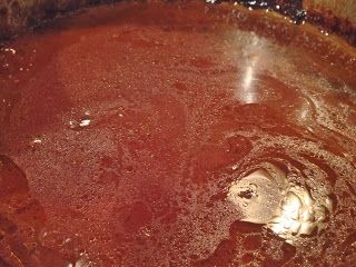 a pot filled with liquid sitting on top of a stove