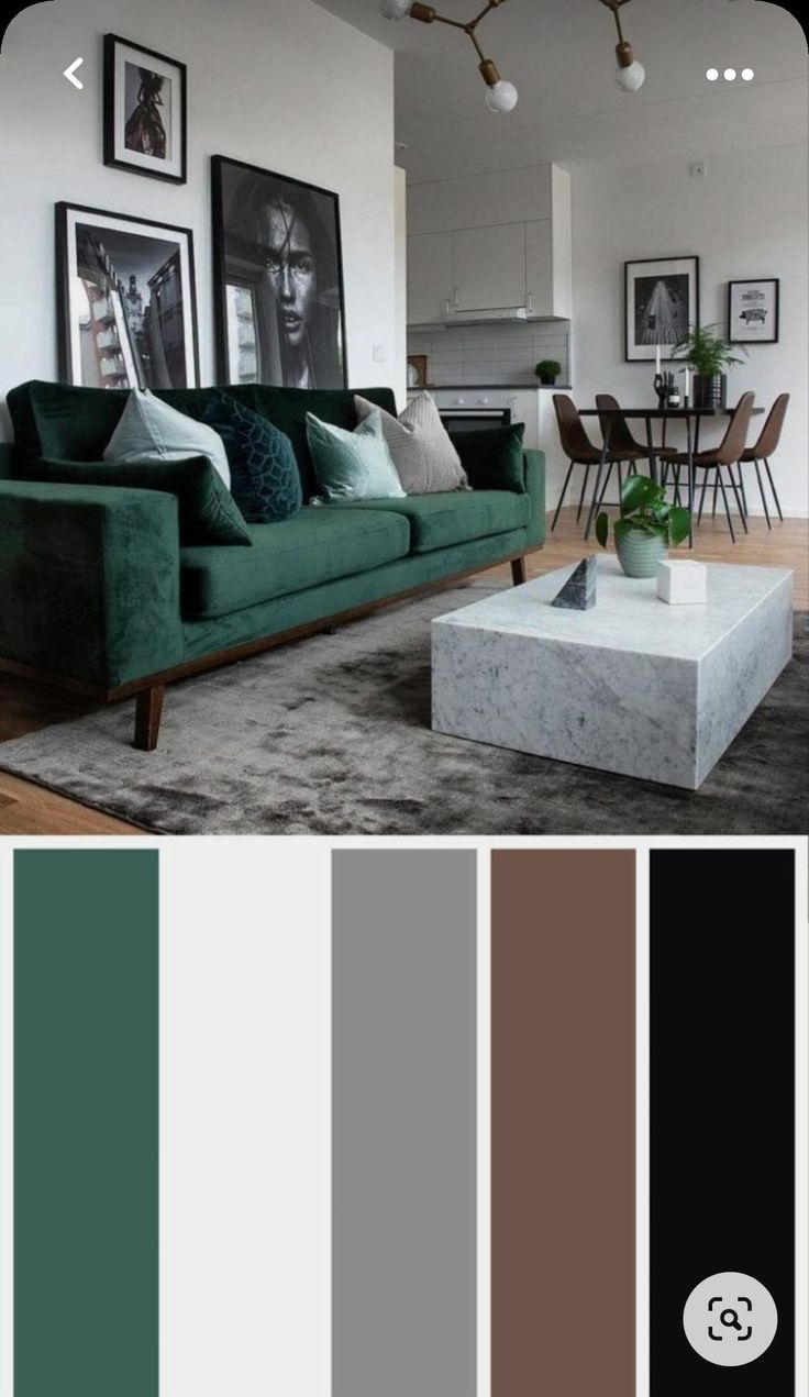 a living room with green couches and pictures on the wall above them in shades of brown, teal, black and white