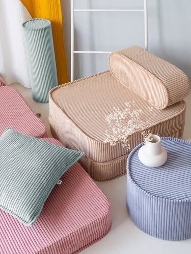 four different colored cushions and two vases