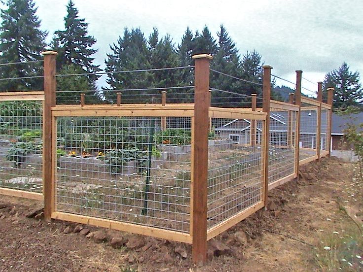 the fence is made of wood and wire