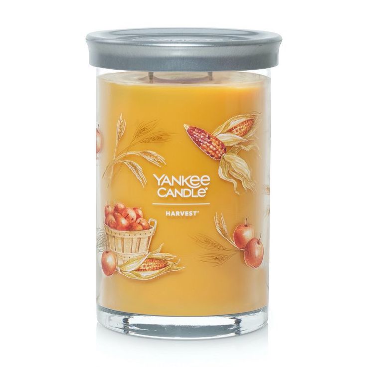 yankee candle with an image of apples and corn on the front, in a glass jar