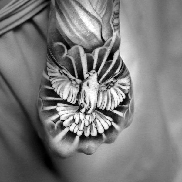 a black and white photo of a person's hand with a bird on it