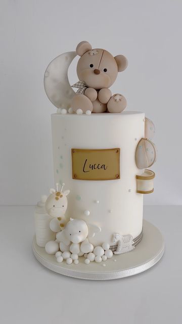 a cake with a teddy bear sitting on top of it