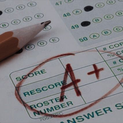 a pencil is sitting on top of a score sheet with the number 4 and cross mark