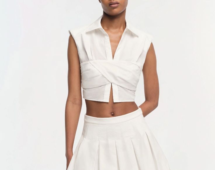 The Emie Top in White. This cropped top features structured, boxy sleeves that add a unique architectural element to its silhouette. The crisp collar and clean lines are complemented by a subtle texture, enhancing its modern appeal. Summer Fragrance, Summer Tanning, Nautical Stripes, Wrap Crop Tops, Blouse Price, Beauty Awards, Hem Top, Women Tops, Outfits For Teens