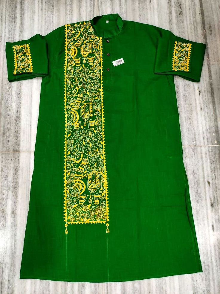 a green shirt with yellow designs on it