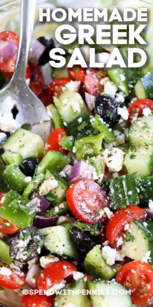 a salad with cucumbers, tomatoes, olives and feta cheese on top