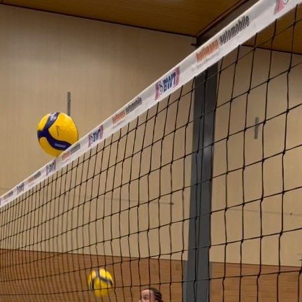 two girls are playing volleyball on the court