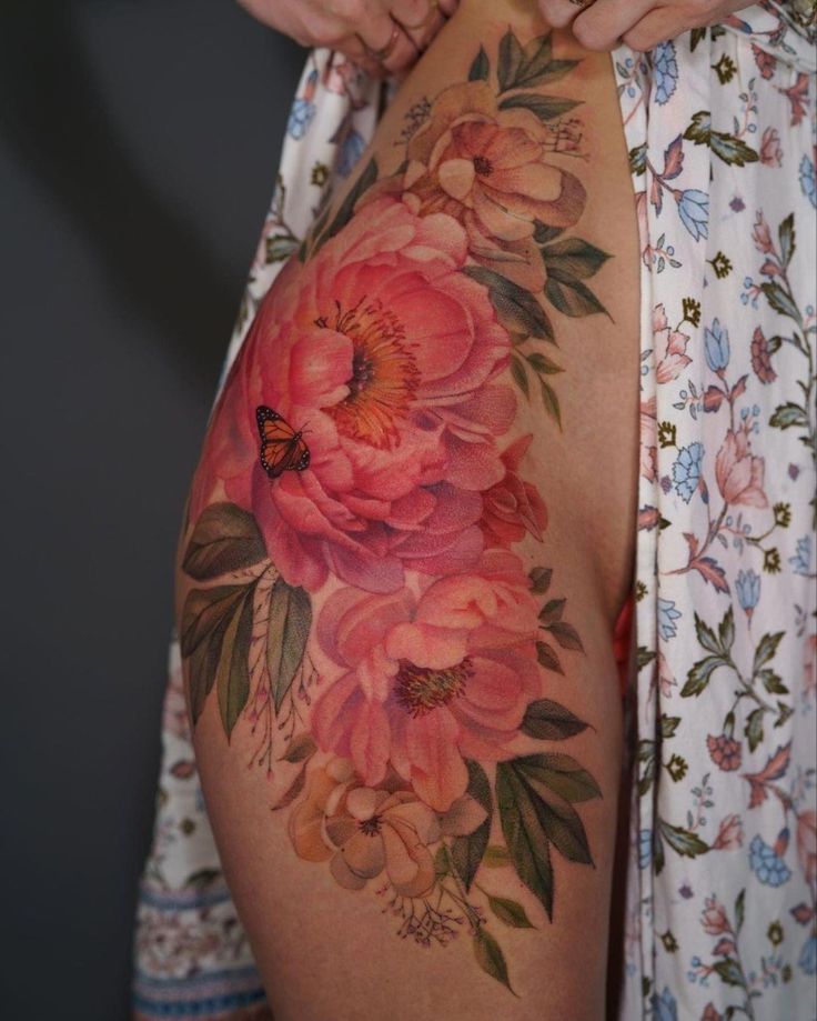 a woman's back with flowers on it and the bottom half of her stomach