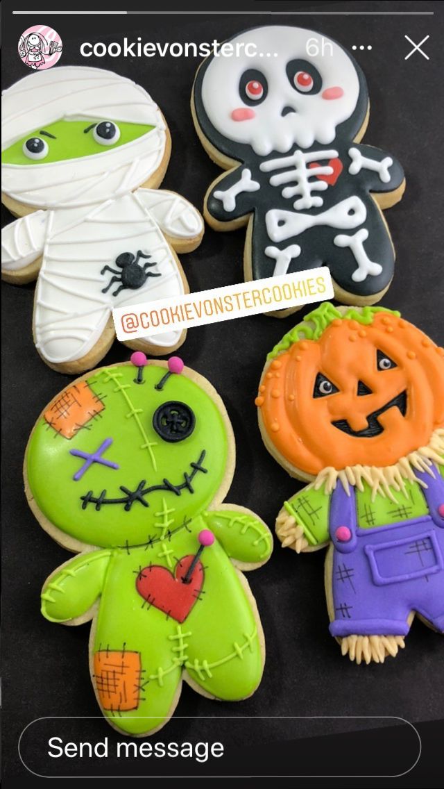 some decorated cookies are sitting on a black surface with the caption'send message '