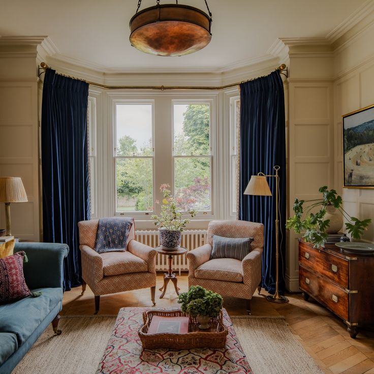 a living room with two couches and a coffee table in front of a large window