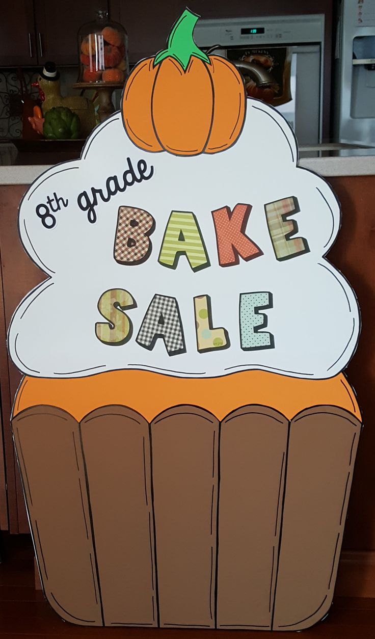 a large sign that says gyr grade bake sale on top of a cupcake