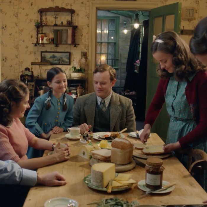 a group of people sitting around a wooden table