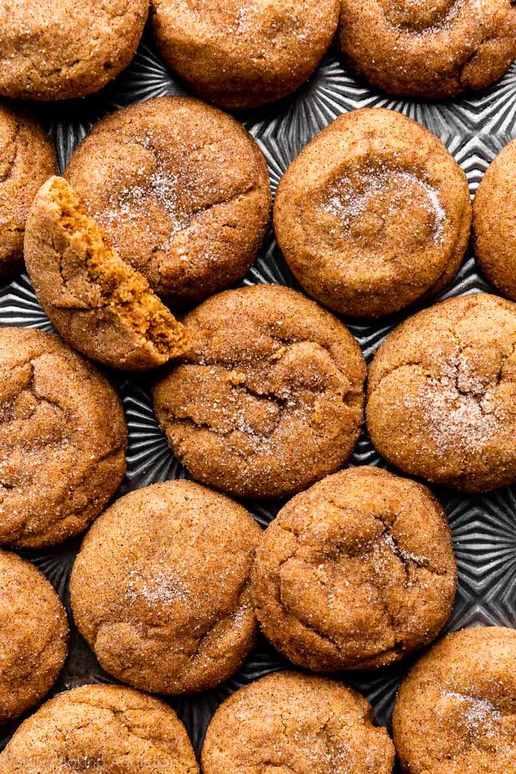 freshly baked ginger cookies on a plate with a bite taken out of the one cookie