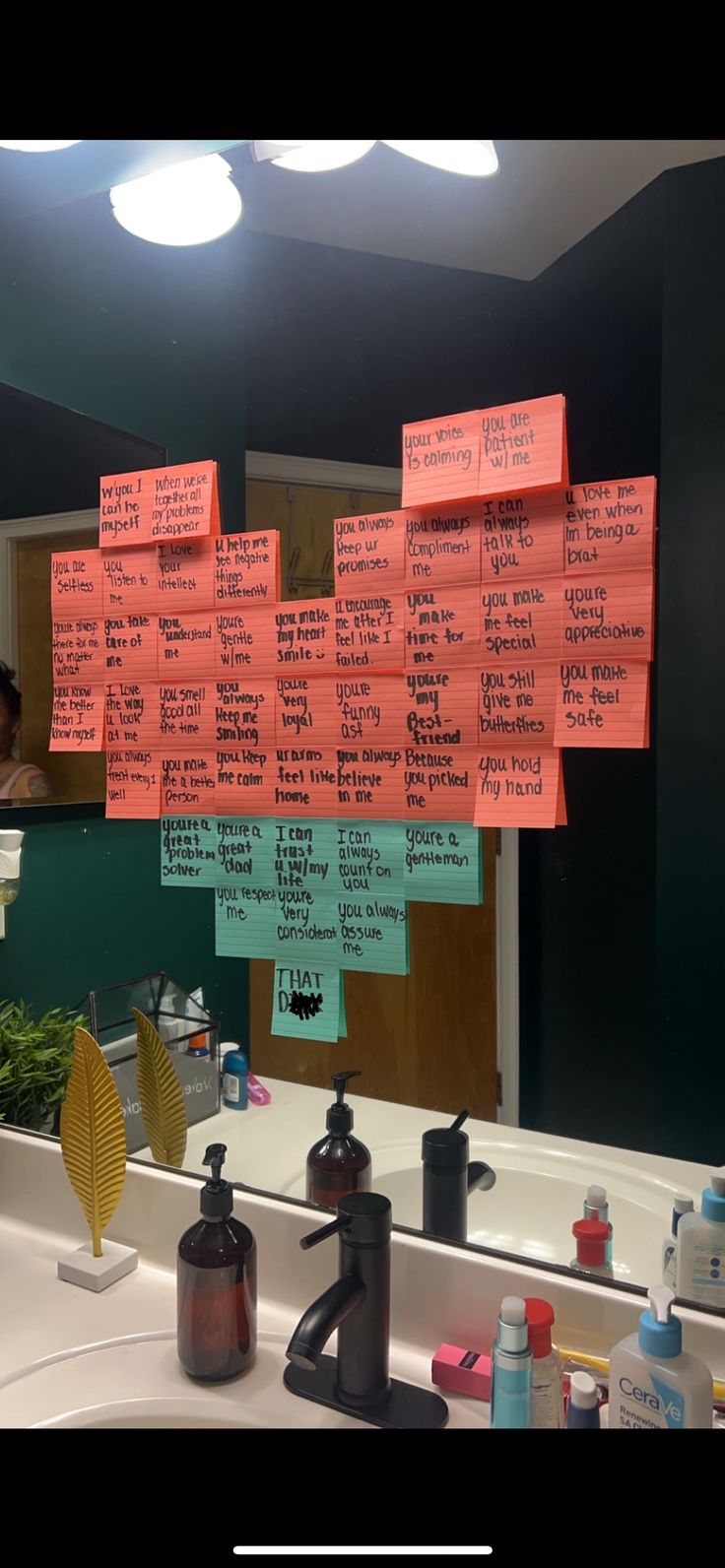 a bathroom sink with several sticky notes on it