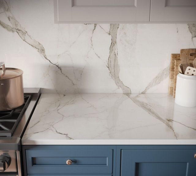 a marble counter top in a kitchen with blue cabinets