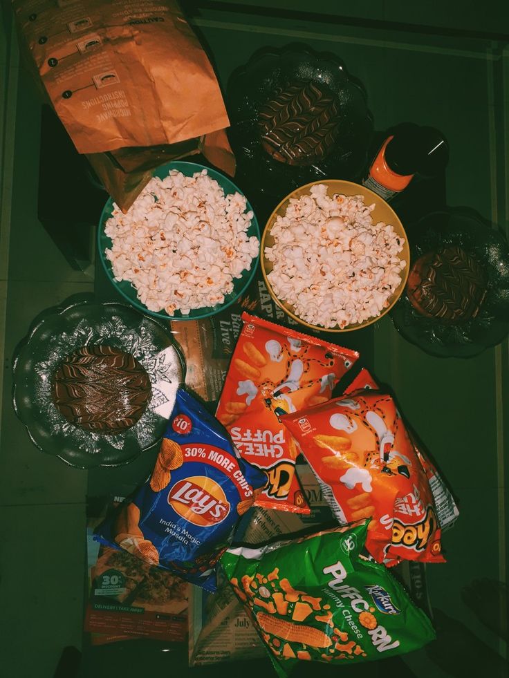 various snacks are sitting on the floor next to each other