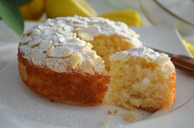 a white plate topped with a cake covered in powdered sugar