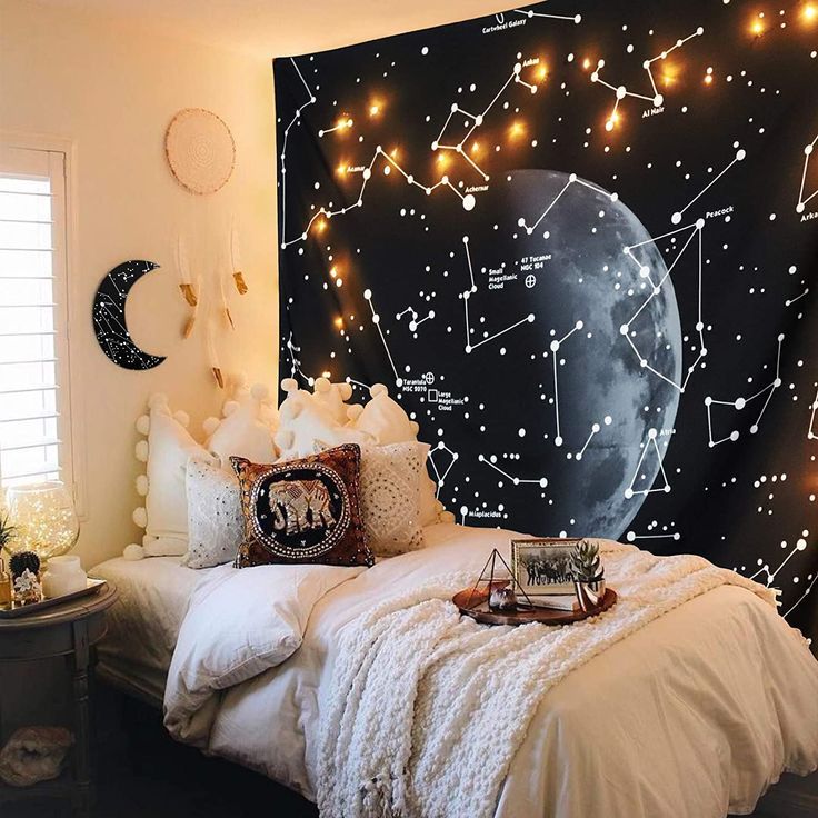 a bedroom decorated in white and black with stars on the wall