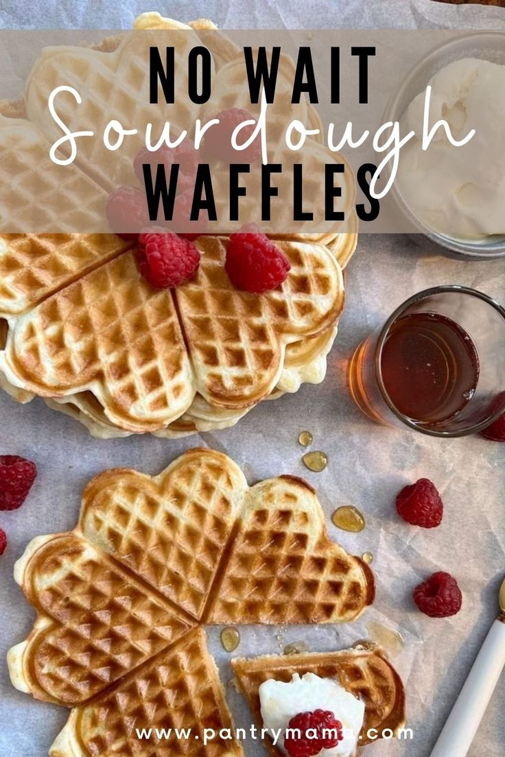 some waffles with raspberries and syrup on the side next to each other