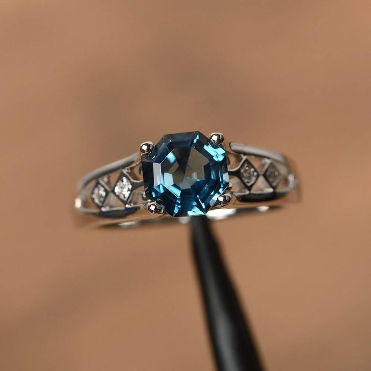 It is a real London blue topaz ring, octagon cut, measures 7mm*7mm, weight about 1.86 cts. The basic metal is sterling silver and plated with rhodium. To change the metal to a solid gold (white/rose) or platinum is also available, please ask for a quotation if you want. You can also go to my shop Home for more elegant rings: https://www.etsy.com/shop/godjewelry?ref=hdr_shop_menu London blue topaz is birthstone of November More London blue topaz rings: https://www.etsy.com/shop/godjewelry?ref=sel Blue Topaz Rings, Topaz Wedding Ring, Topaz Rings, London Topaz, November Birthstone Ring, Blue Gemstone Rings, Cute Engagement Rings, Aquamarine Engagement Ring, Blue Stone Ring