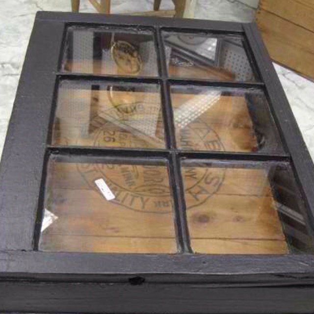 a coffee table with four glass panes on it