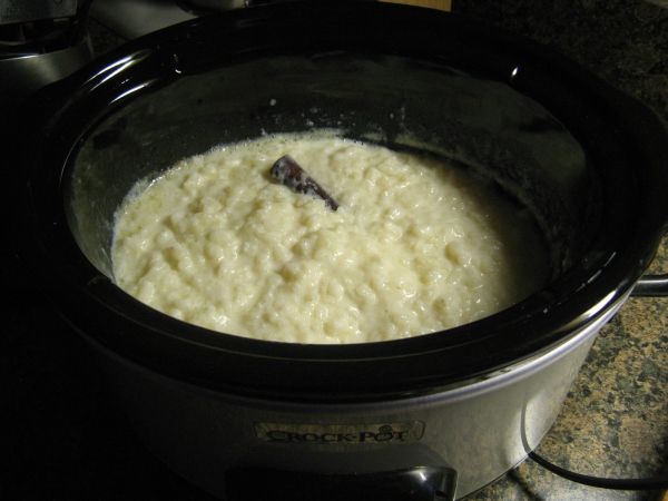 a crock pot filled with food sitting on top of a stove