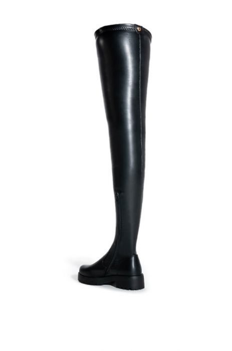 The SURGICAL boot is a signature silhouette and best seller from our 4-Way-Stretch collection. These feature a thigh high length, chunky lug sole, and a round toe. The shaft is made with our 4 Way Stretch material: a buttery soft faux leather that will mold to the shape of your leg for a sleek and secure fit. Style this closet staple with any outfit you have in mind for an effortlessly chic look.